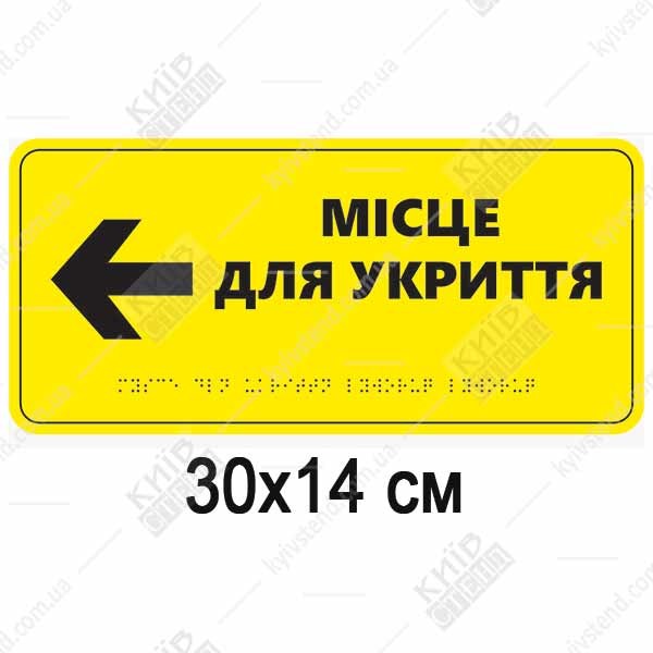 Тактильна табличка місце для укриття ліворуч зі шрифтом Брайля на спіненому пластику, встановлена на стіні коридору.
